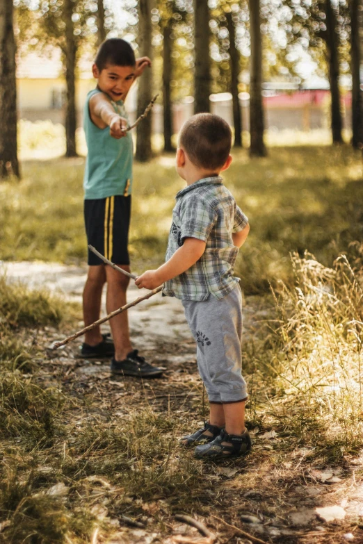 a little boy holding soing on the end of a stick