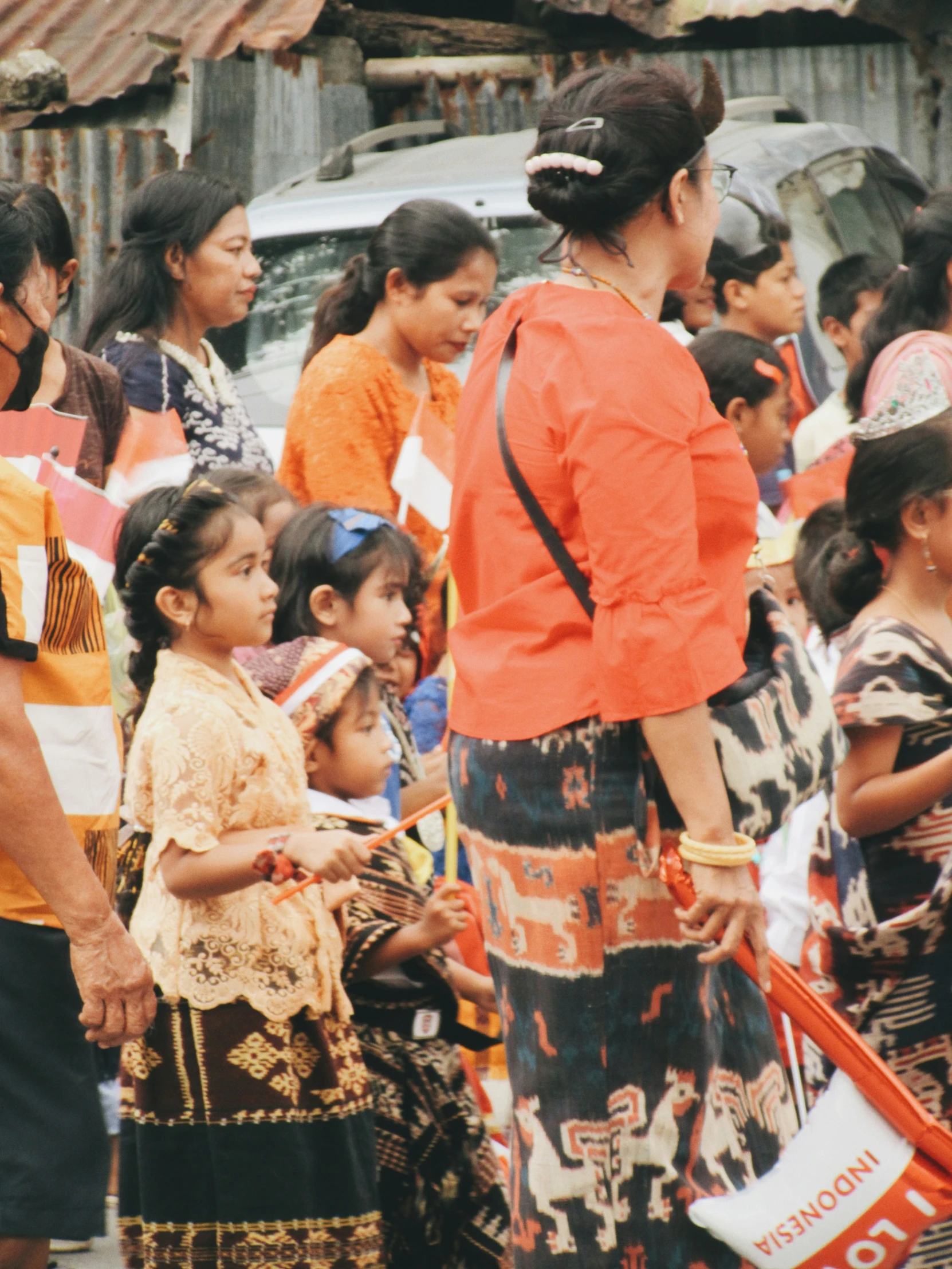 a woman is standing near several children