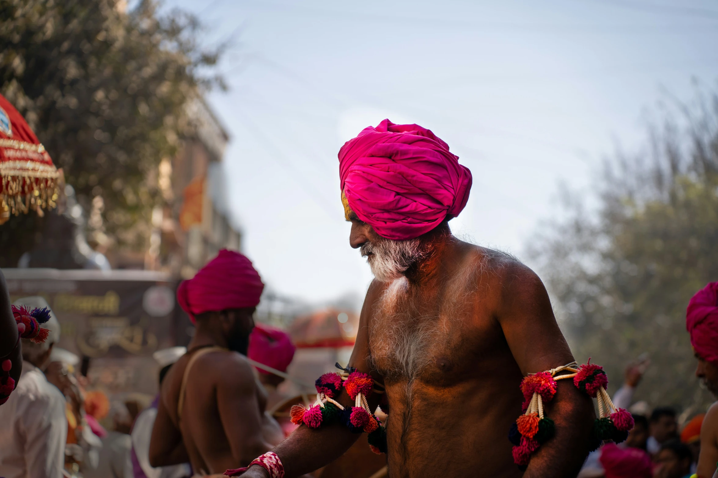 a man dressed in pink turban and some other men