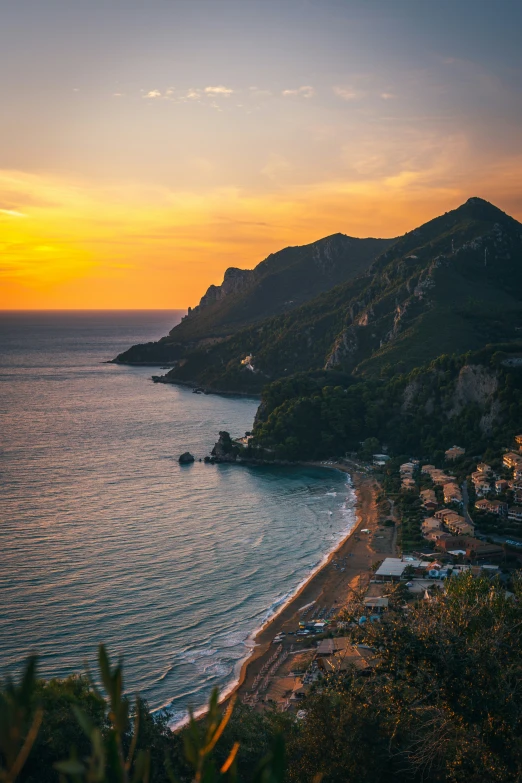 a beautiful sunset seen in the distance over a beach