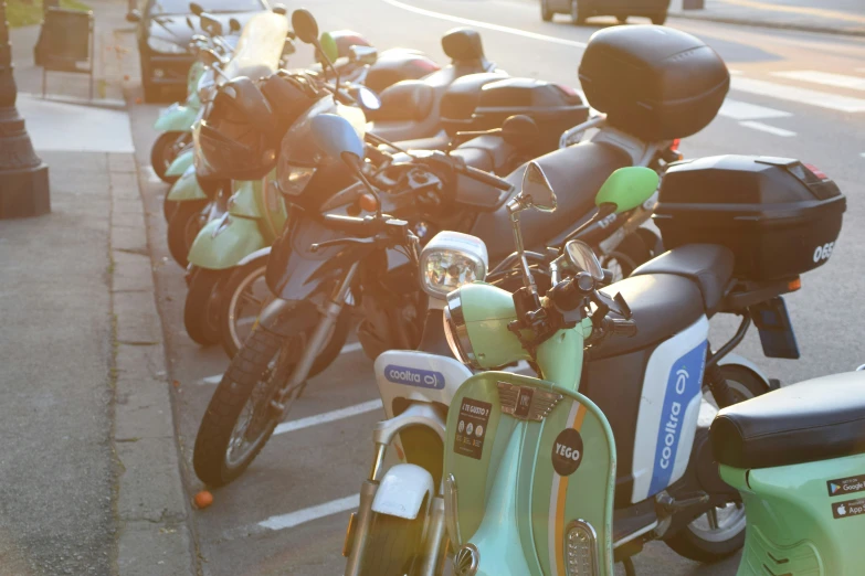 several motorcycles are parked on the sidewalk