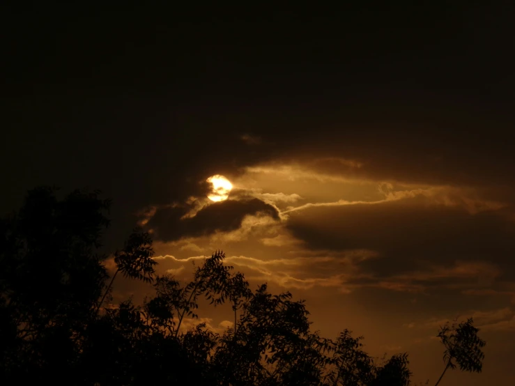 a sun is shown peeking out through some clouds