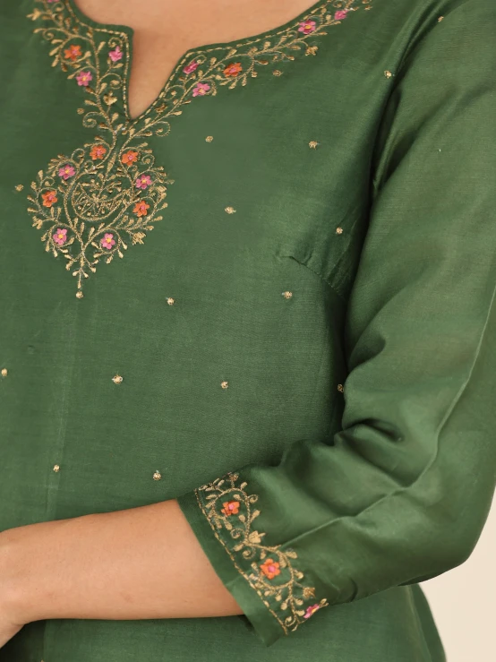 a close up of a woman wearing a green dress