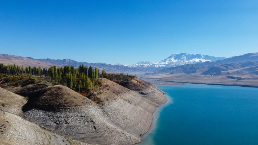 the view from a high viewpoint overlooking the lake and mountains