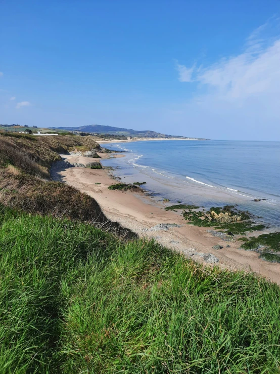 a body of water surrounded by lush green grass