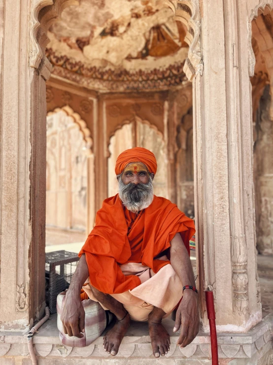 a man sitting on a stone staircase next to a doorway