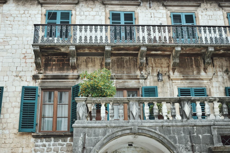 a couple of buildings with shutters that are closed