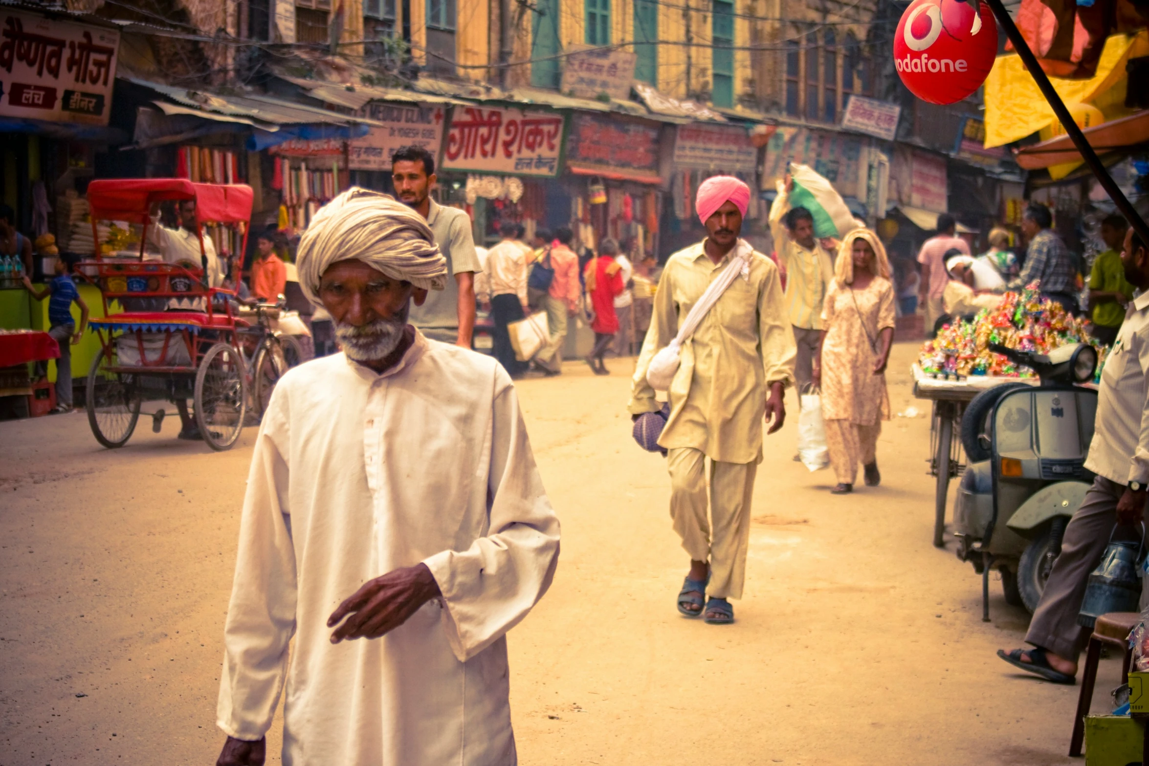 a man walking down a city street in front of shops