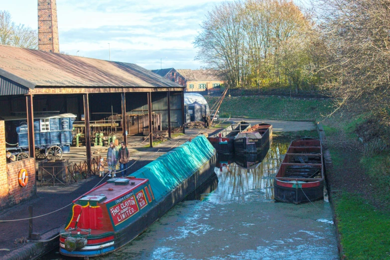 some small boats parked along a house near water