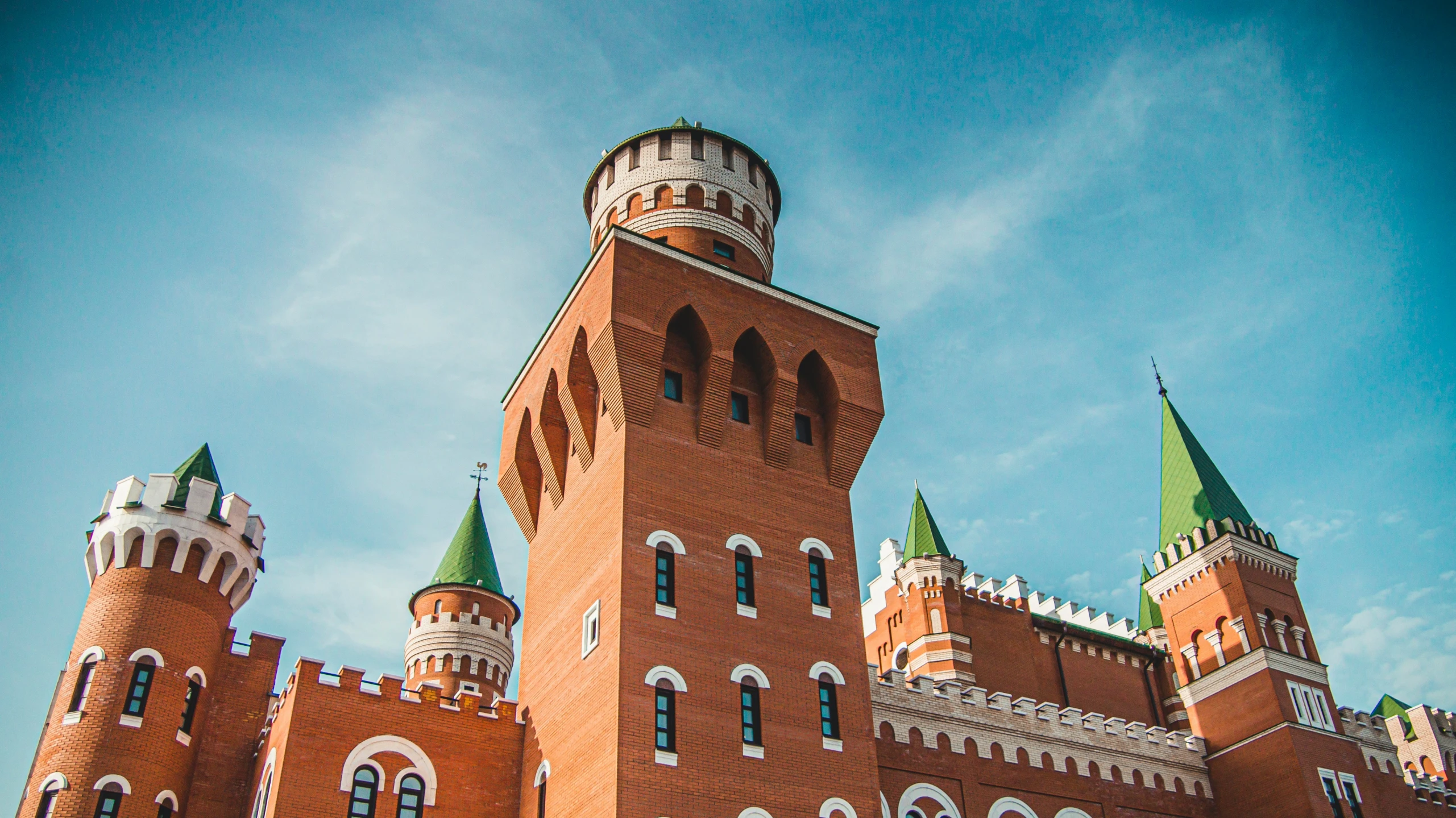 a building has two towers with green top