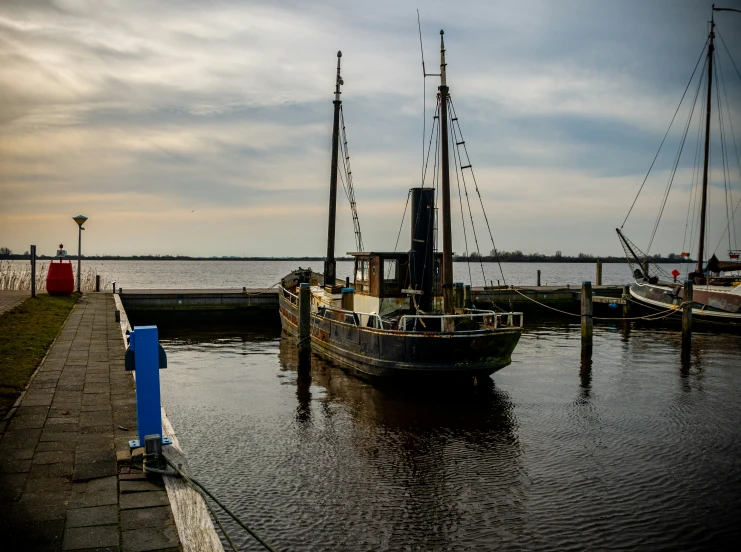 the ship is anchored near the water's edge