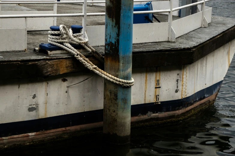 a blue and white boat docked at the docks
