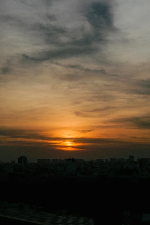 sunset over a city with very dark clouds