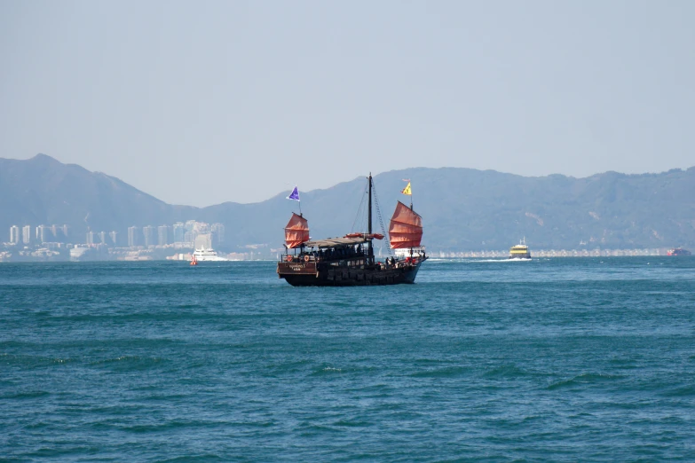 a large ship sailing in a very blue ocean