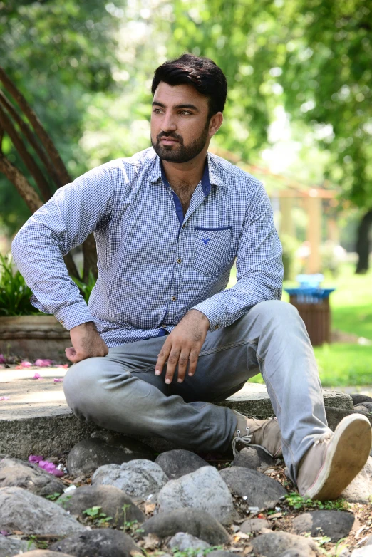 a man sitting down with his hands on the ground