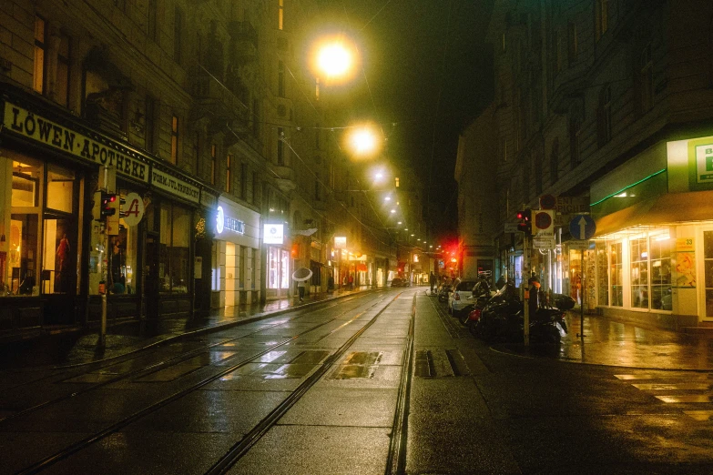 a dark street at night with several lights on