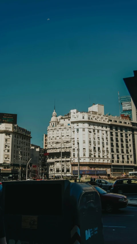 a city street filled with traffic and tall buildings