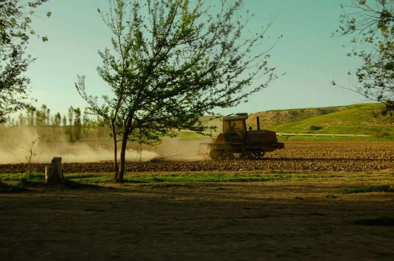 the tractor is pulling the plow on the field