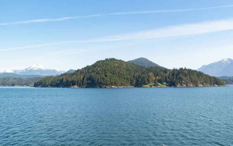 a large body of water with mountains in the background