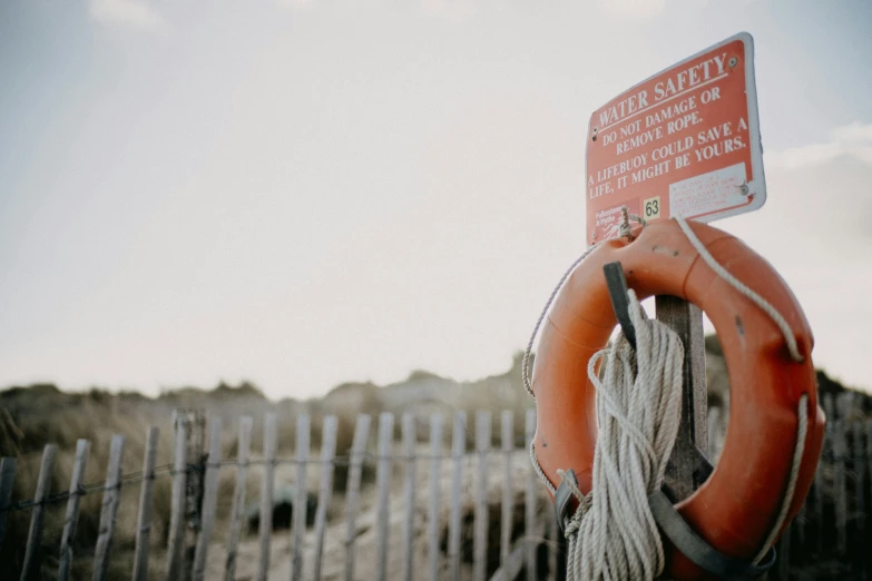 a life preserver sitting on top of a wooden gate