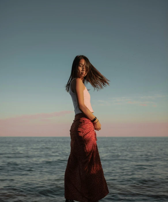 woman on beach near large body of water