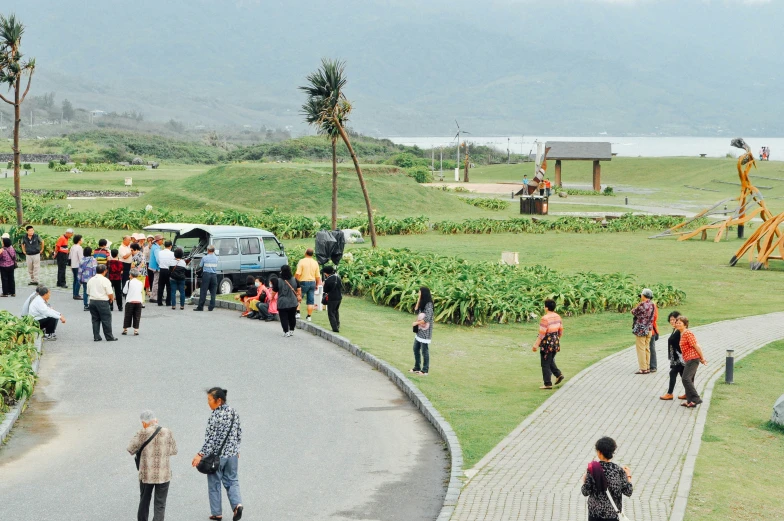 a group of people walking on the side of a road