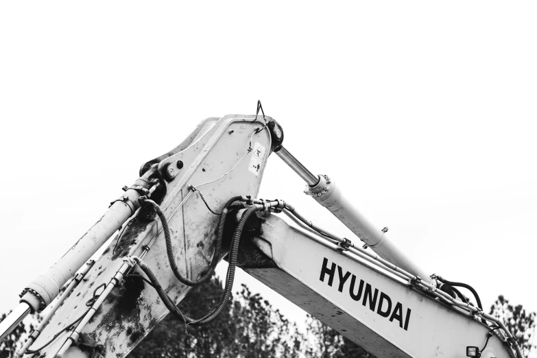 a large white crane lifting a sign up to the sky