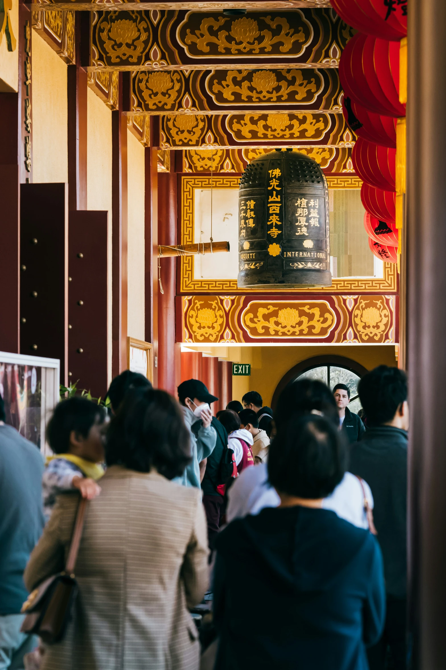 people walking in line under chinese themed decorations