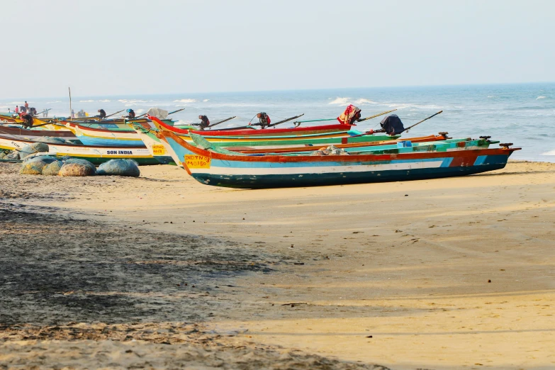 an empty beach with some small fishing boats