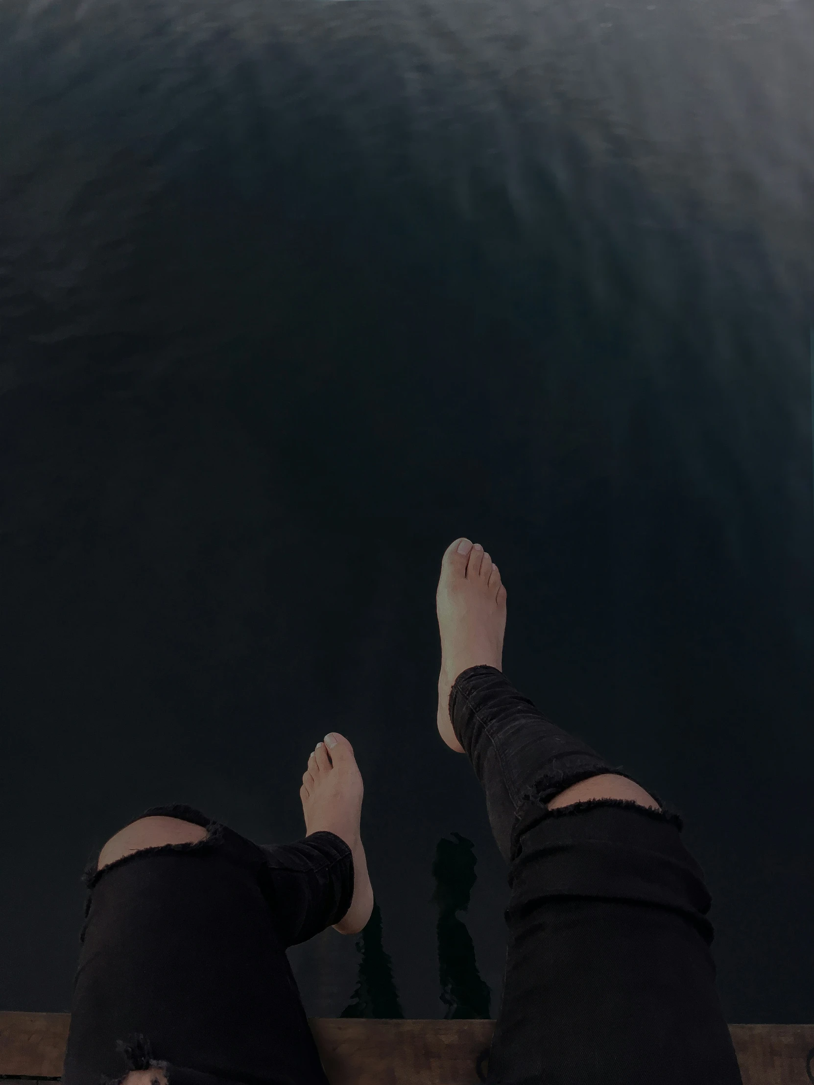 people standing next to the water on the dock