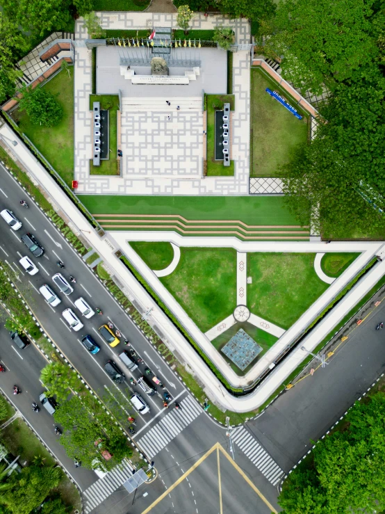 a square with a fountain and cars parked in it