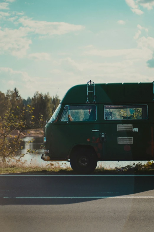 a dark green van parked on the side of the road