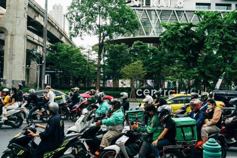 a large group of motorbikes are riding down the street