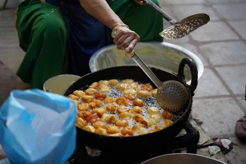 a person stirs food in the pan on the stove