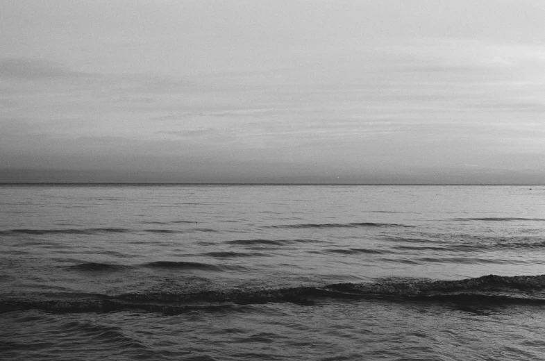 black and white po of the ocean in twilight