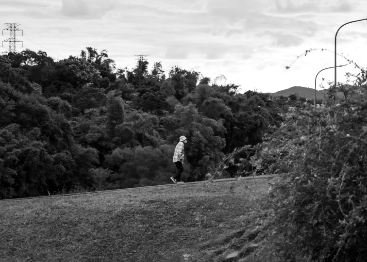 the boy stands alone in a grassy field