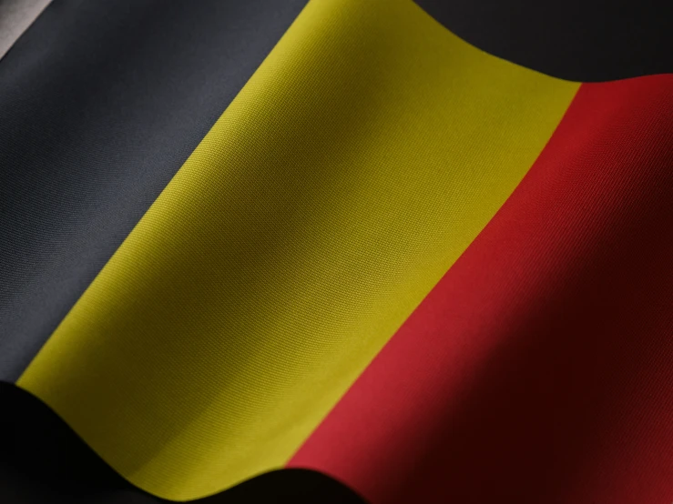 a large flag with yellow, red and black