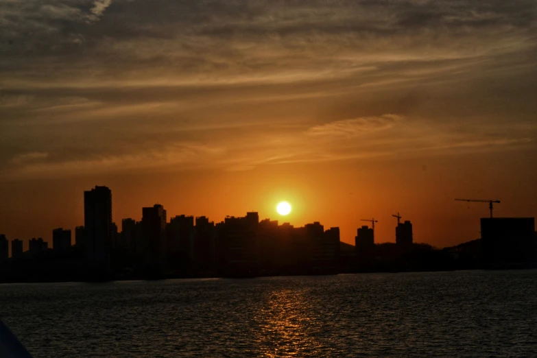 a large city skyline sits across from the ocean