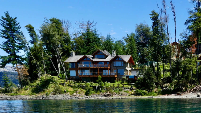 a large house sitting on top of a lush green forest