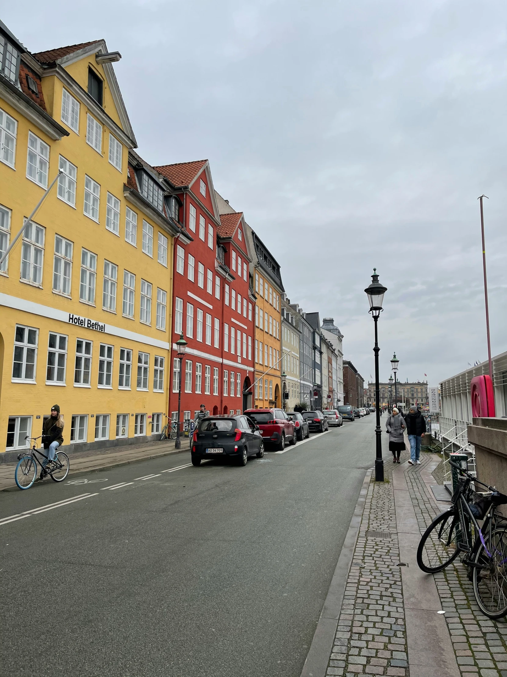 an image of some people riding bikes down a street