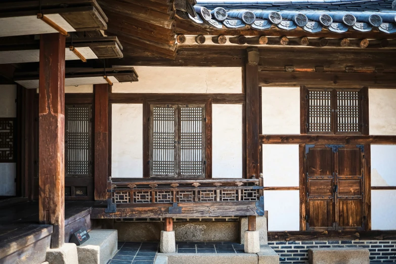 an old looking building has a bench in front