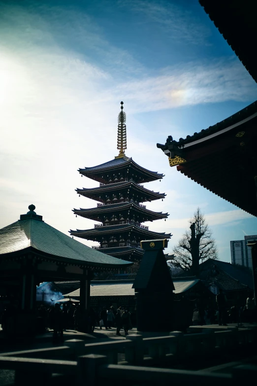 the top of a pagoda sits in the middle of the sun
