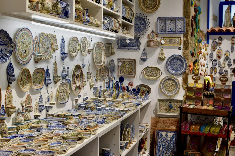 there are many blue and white plates on display