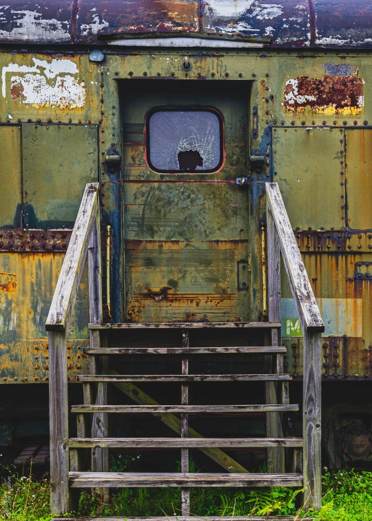 an old train car with stairs leading up to it