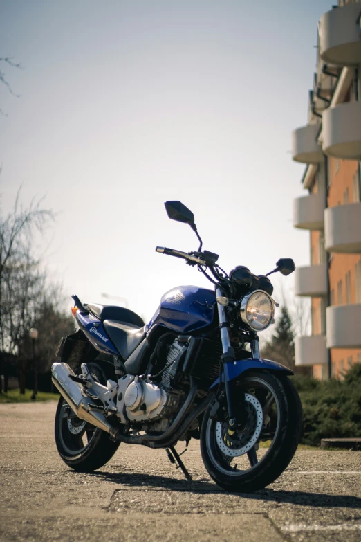 a motor bike parked in front of a multi story building