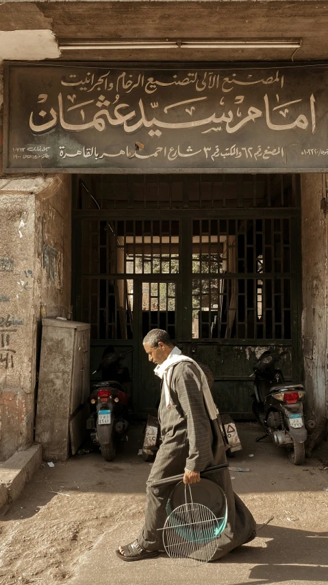 a man with a basket walking in front of a building