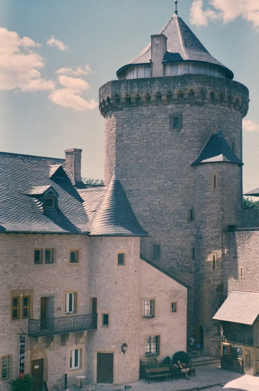 a building with a turret and three story house next to it