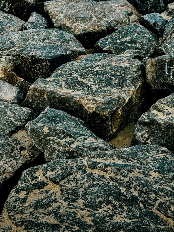 black and white rocks in the sand with little pebbles