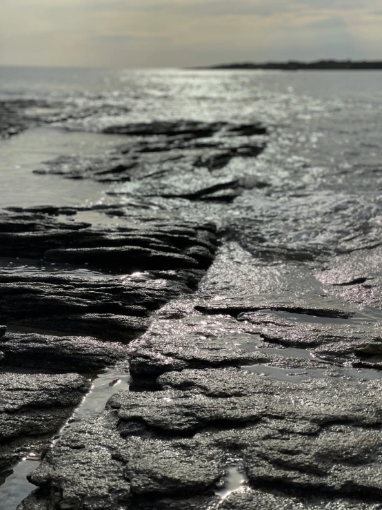 long exposure of rocks lined up with water and sky