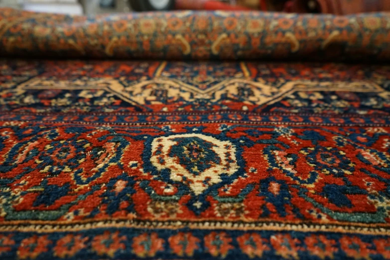 an elaborate carpet with multiple colored oriental carpets